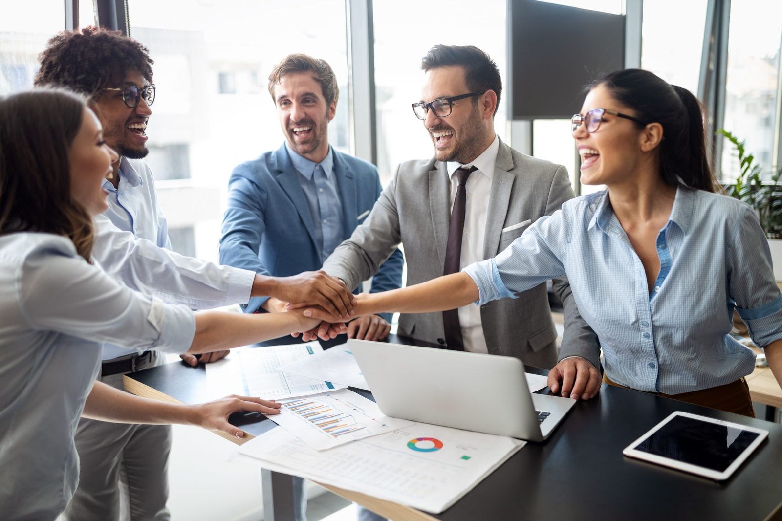 Team members joining hands
